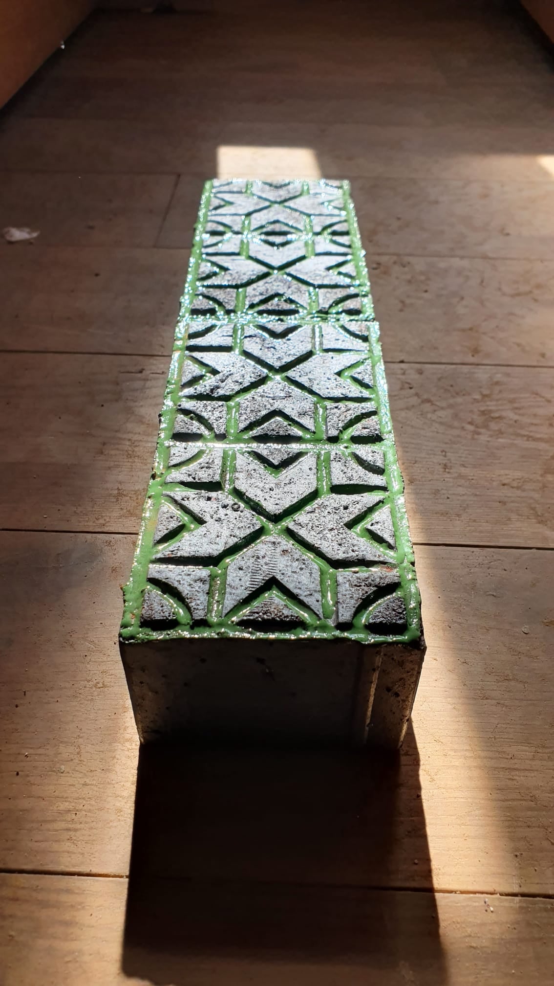Glazed brick with green geometric relief pattern by Maria Gasparian