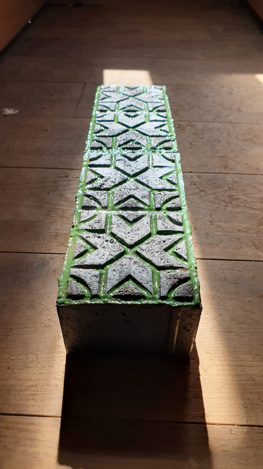 Glazed brick with green geometric relief pattern by Maria Gasparian