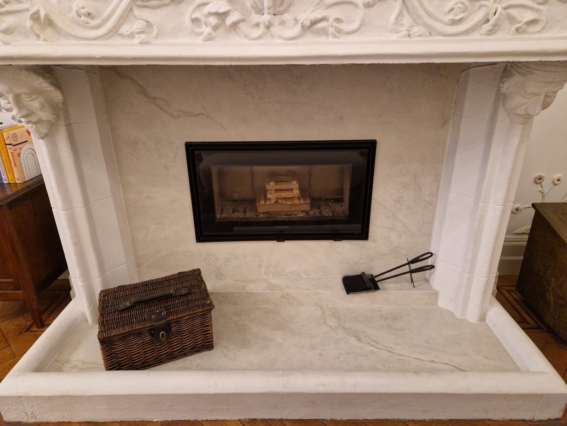 Carved stone fireplace with marble slips and hearth, fabricated and installed by Geology Ltd